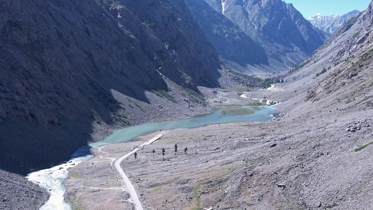 High-altitude aerial view of Mahodand Lake basin nestled between steep rocky mountains in Kalam Valley, Khyber Pakhtunkhwa, Pakistan. Glacier melt alpine landscape in summer