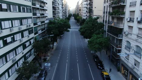 a deserted street in argentina with high-rise buildings and greenery, capturing the modern urban environment