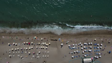 People-Sunbathing-On-The-Beach