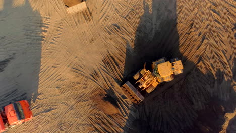 aerial view of construction site with bulldozer and dump truck