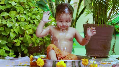 cute toddler baby boy bathing in decorated bathtub at outdoor from unique perspective