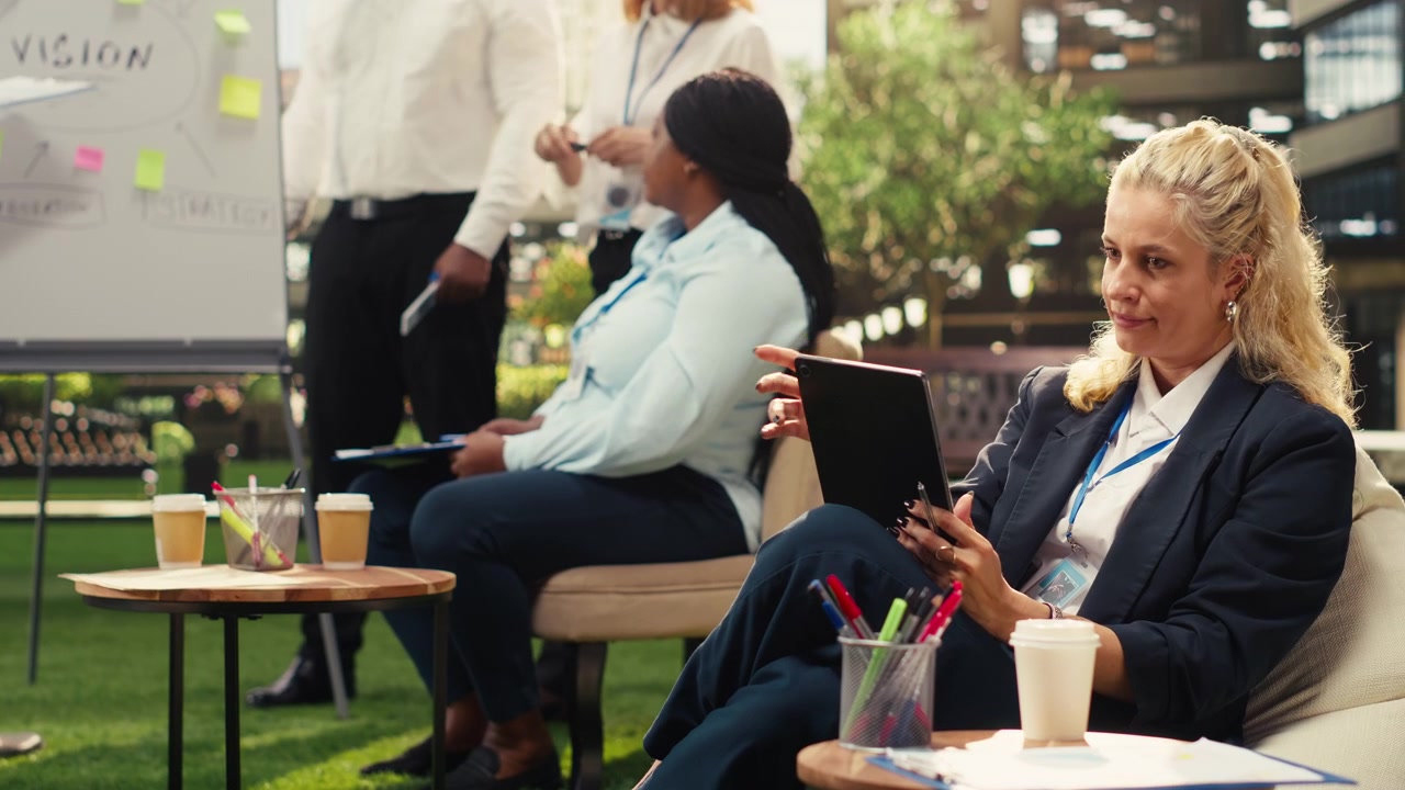 Businesswoman Using Tablet During Collaborative Office Meeting