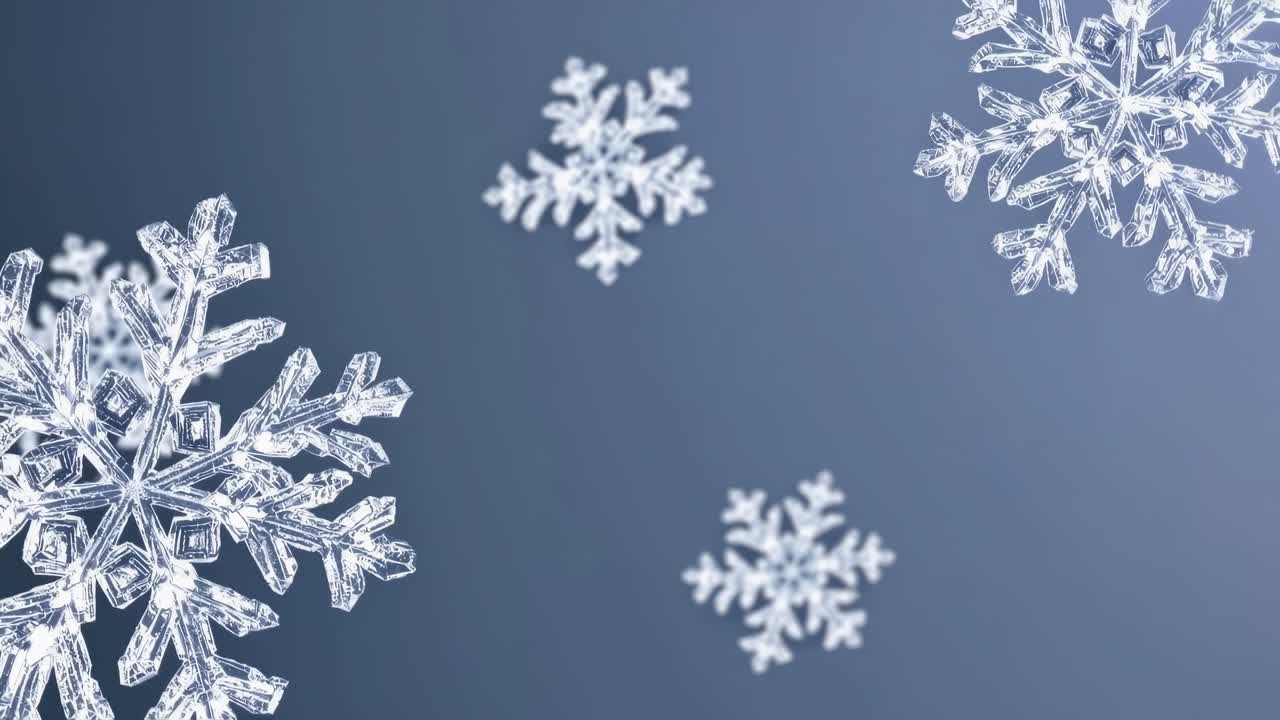 Close-up video of intricate snowflakes against a blue background, captured from a slightly tilted