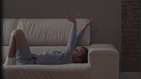 playful child wants to catch laser dots of christmas illumination