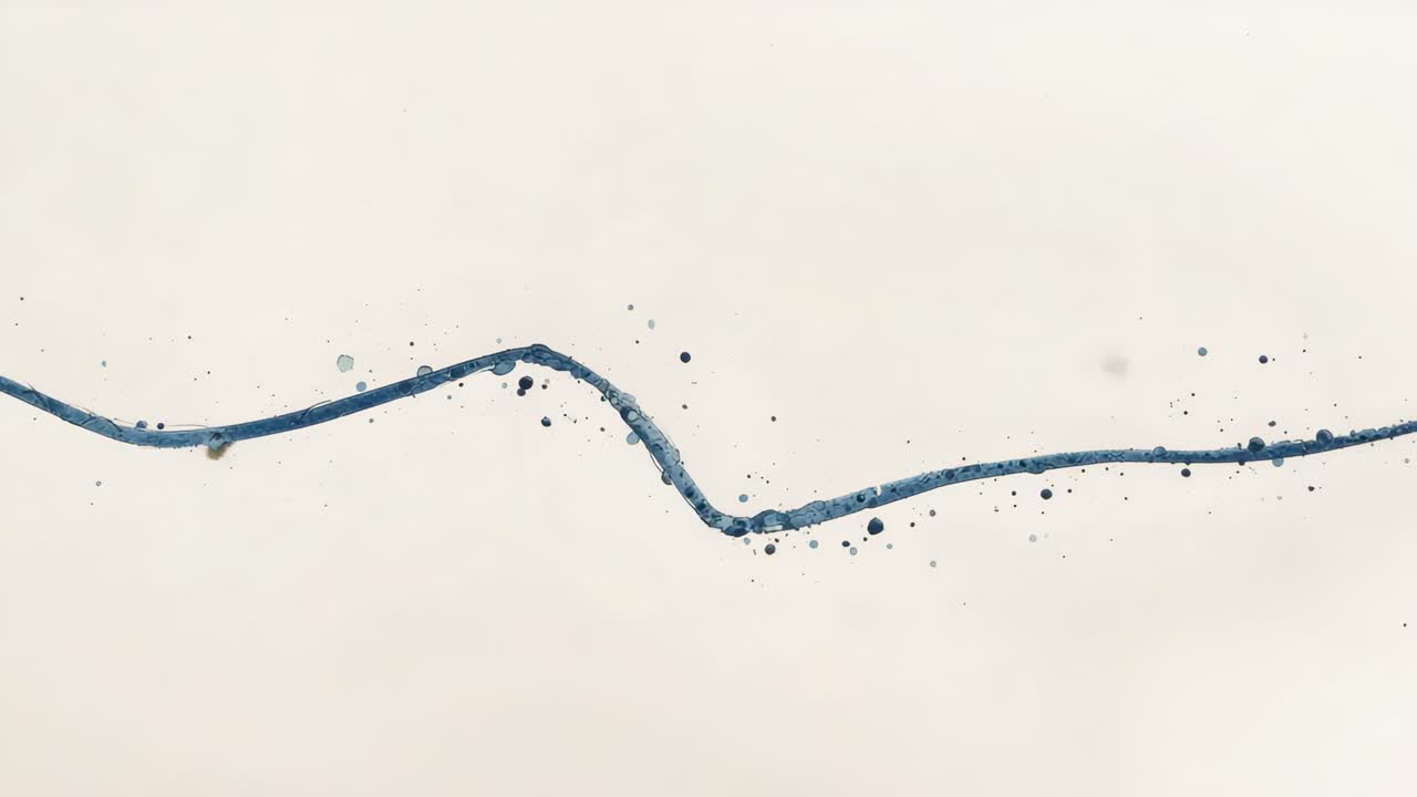 Emerging blue stroke crossing warm beige textured paper from left edge, shedding specks settling