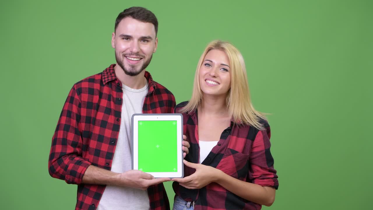 Young couple showing digital tablet together
