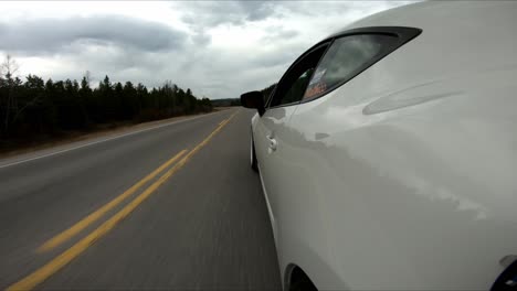 side view of a car driving in the highway