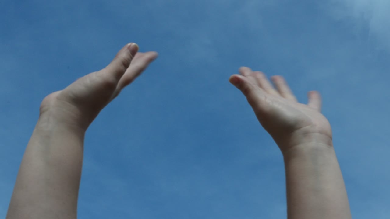 Hands against the sky. Various emotions