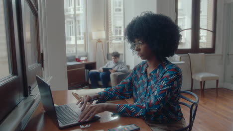 young african-american businesswoman working on laptop at desk