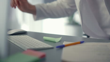 Doctor-sitting-desktop-using-computer-in-hospital-closeup.-Technology-in-clinic