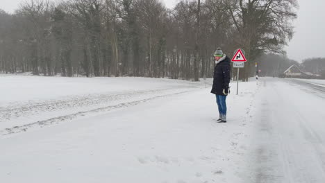 man dives on the highway full of snow during snowstorm in germany