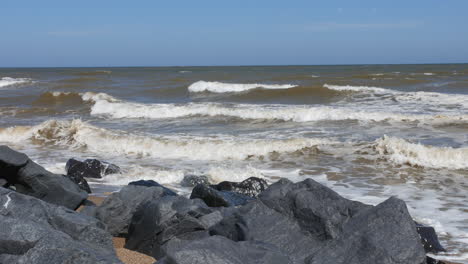 waves rollin in from the sea crashing on to rocks