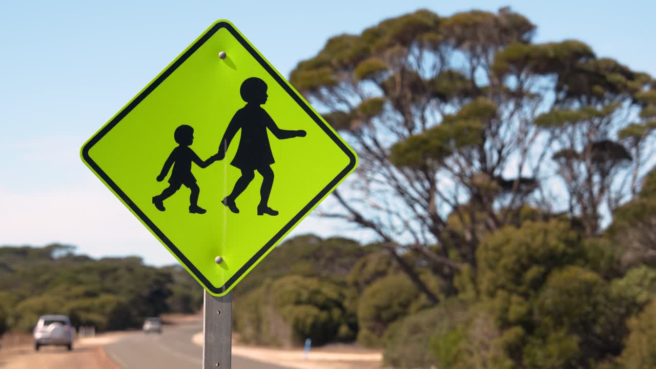 Close-up of pedestrian crossing sign warning drivers of children - rural Australia road scene