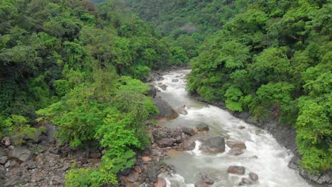 4k aerial flying backward shot of a river stream in the forests of khasihills, cheerapunji, meghalaya, india