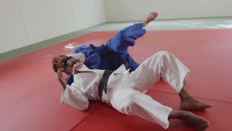 judokas fighting and immobilizing on the ground