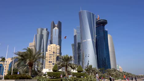 the skyline of commercial center of doha, the capital of qatar. bottom view with wide angle on skyscrapers and small kite