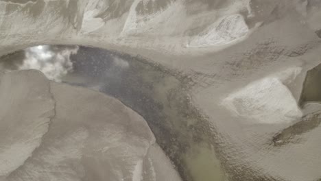 aerial top-down shot of the drying riverbed with just few small ponds remaining