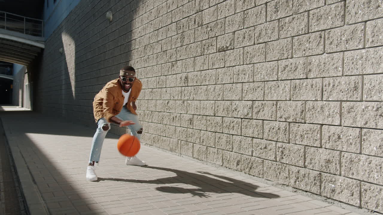 Man Playing Basketball in the City