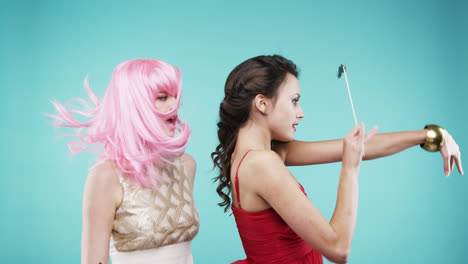 Girlfriends-dancing-wearing-red-dress-and-pink-hair-in-slow-motion-party-photo-booth