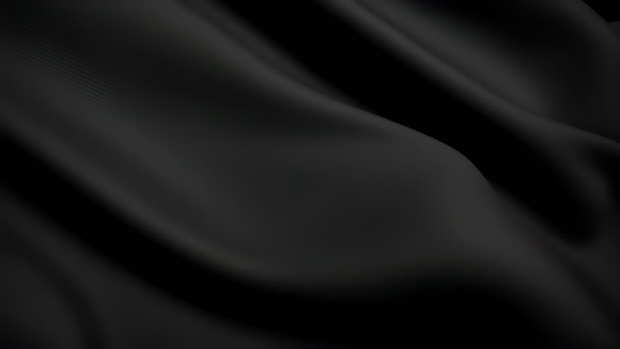 エレガントな黒い生地の波が、滑らかで流れるような質感を生み出しています。トップダウンのアングルから撮影。