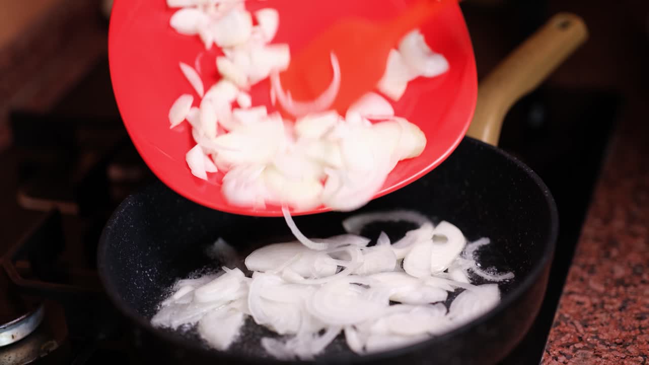 Cooking onions in a frying pan