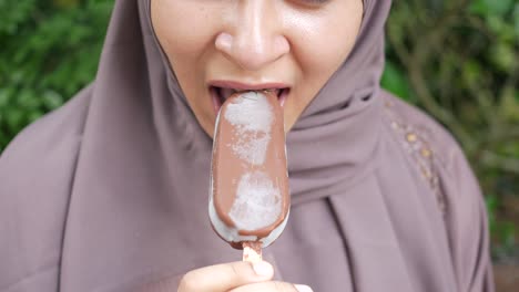 young women eating chocolate flavor ice cream