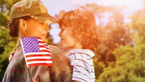 Animation-of-soldier-with-son-and-american-flag-outdoors