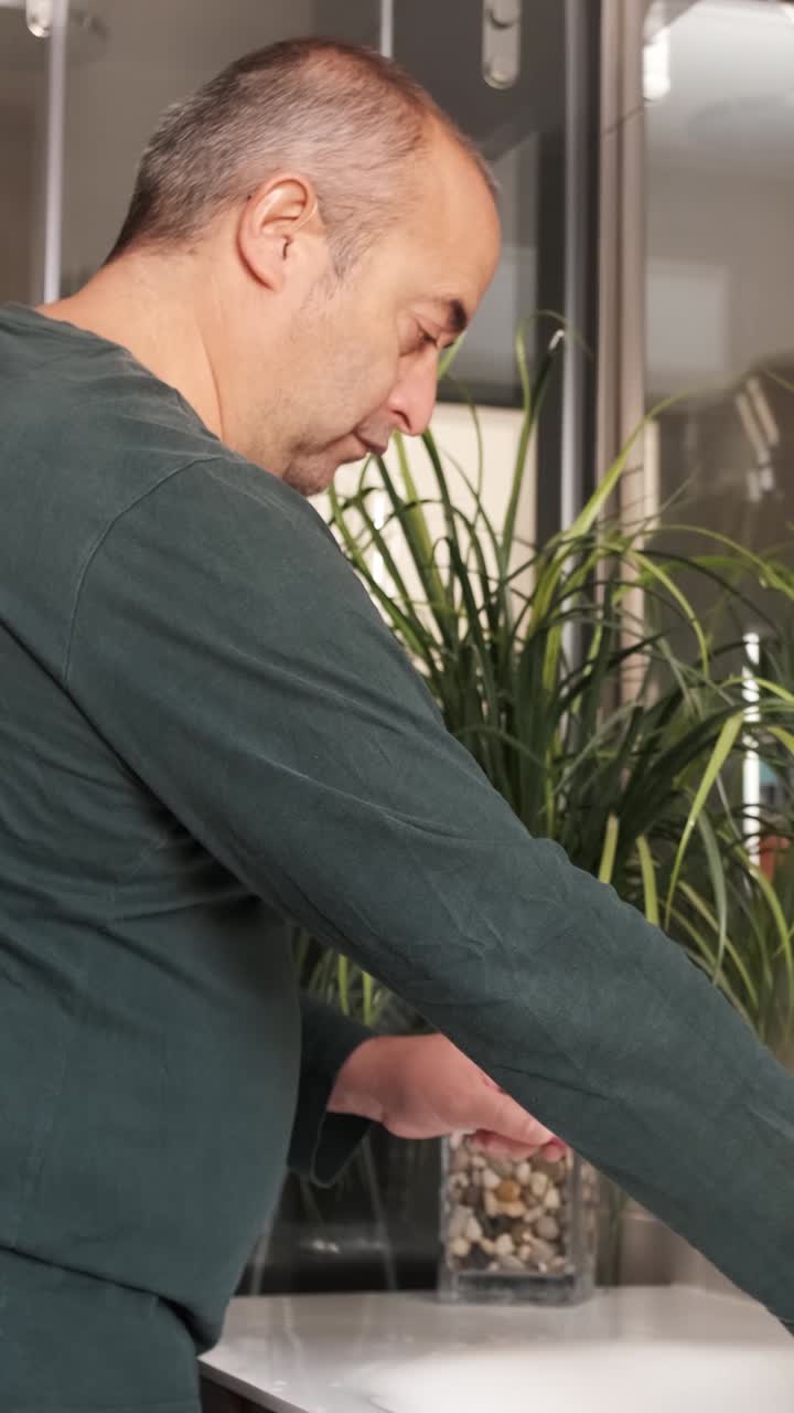 Adult man cleaning his teeth at home
