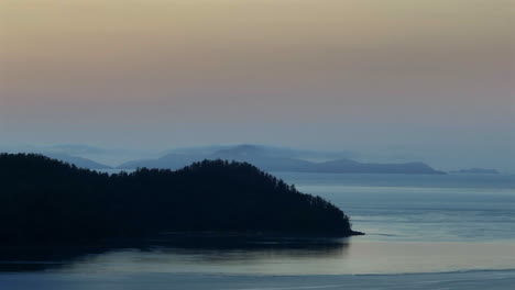 aerial: drone shot of pine forested island during the early dawn in whitsunday islands, qld, australia