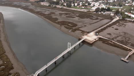 aerial shot orbit over low tide at ria formosa nature park ecosystem