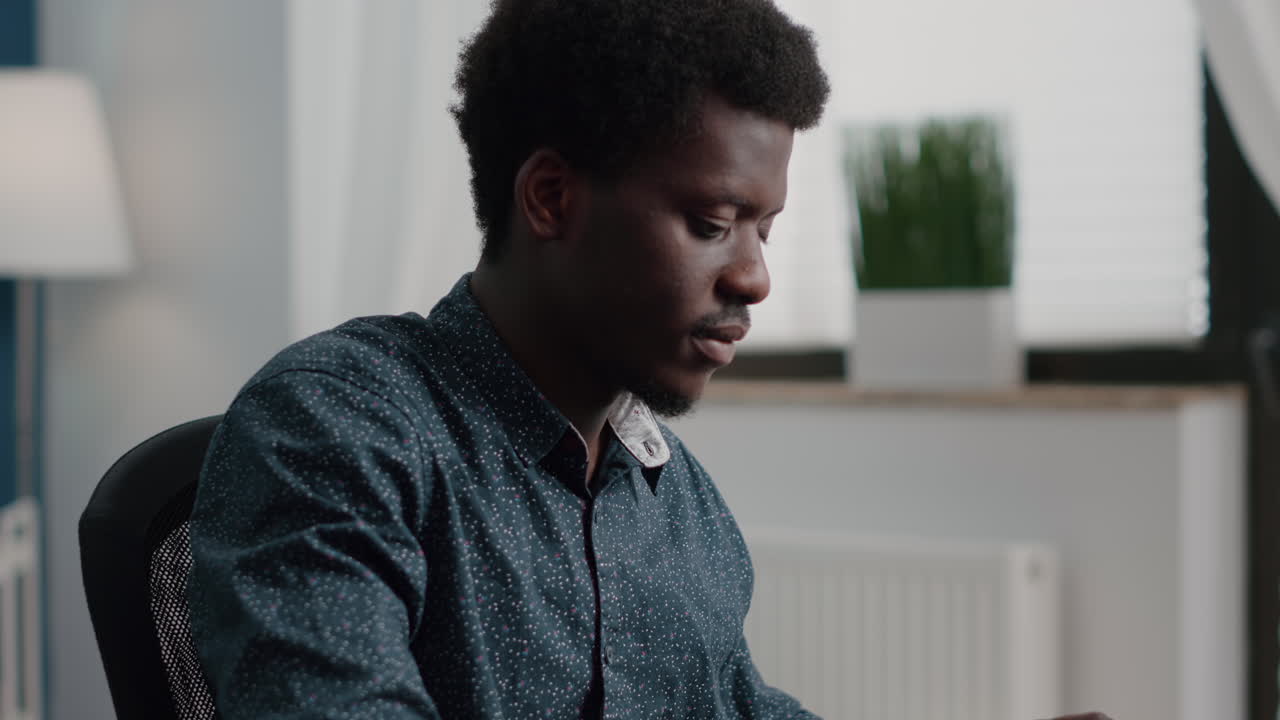 Black african american manager working from home, tuping on computer keyboard