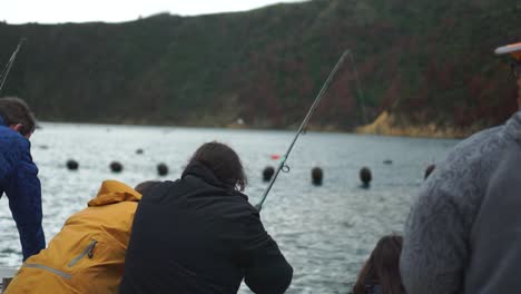 Fisherman-on-boat-reels-and-pulls-fish