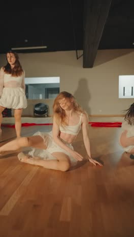 women dancers in white performing contemporary dance