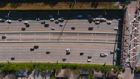 Aerial-of-cars-on-59-South-freeway-in-Houston,-Texas-on-a-bright-sunny-day