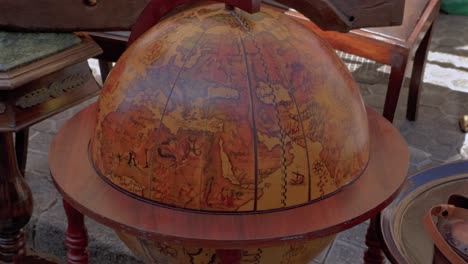 antique world globe wood stand for sale in local spanish market