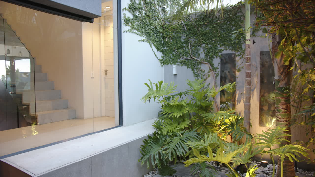 Modern home with large windows and lush garden, showcasing contemporary design