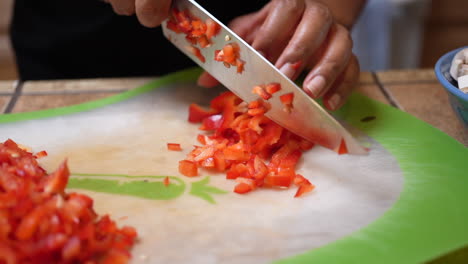 dicing and chopping fresh red bell peppers to add to a vegetarian recipe - slow motion