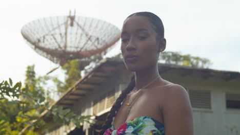 Close-up-of-a-model-with-natural-pretty-face-and-a-tracking-station-in-the-background