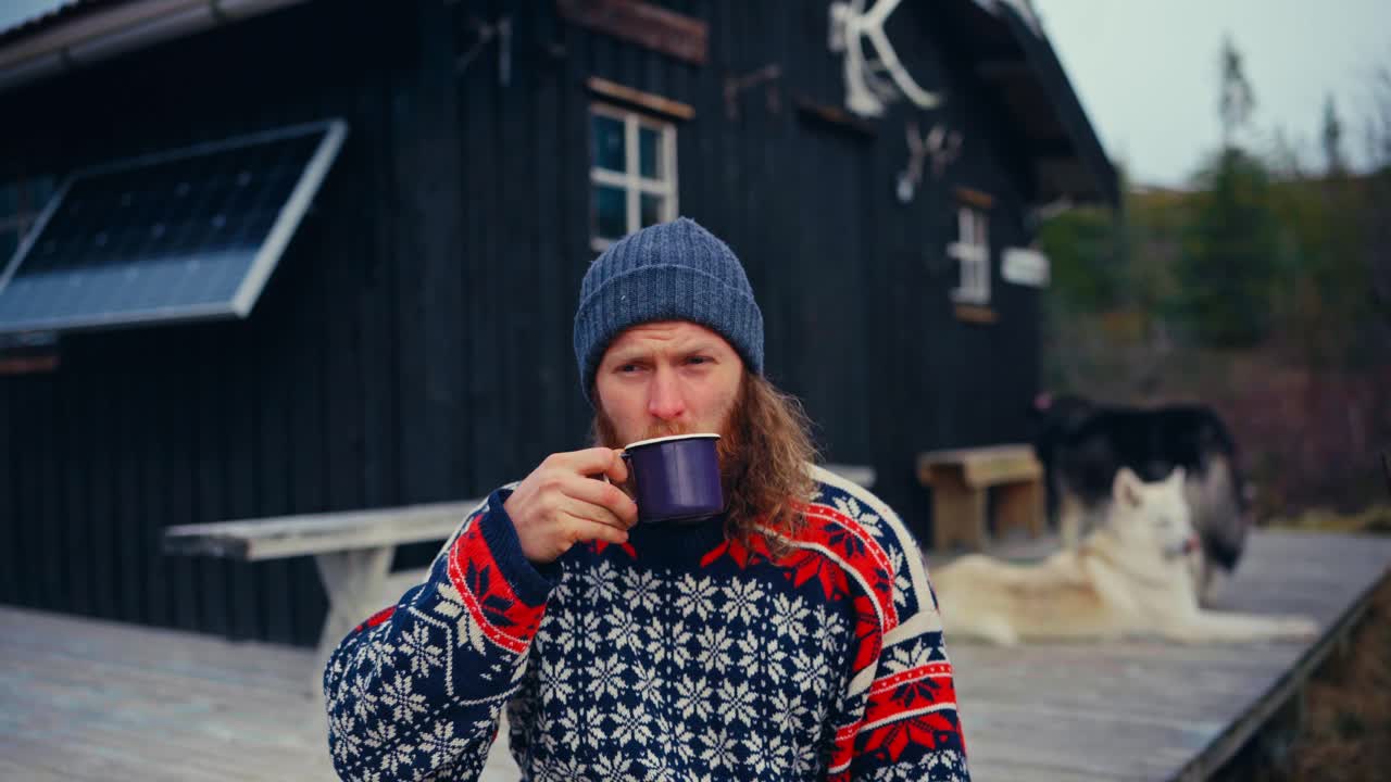 Portrait Of A Norwegian Man Wearing A Knitted Bonnet While Drinking Coffee Outside. Close-up Shot
