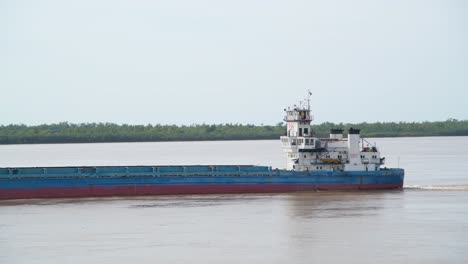 a vessel is sailing slowly on paraná river, argentina