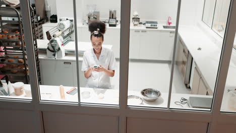 Phone,-restaurant-kitchen-and-woman-chef-working