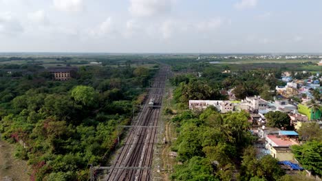 aerial drone shot of railway tracks splitting into the city in india