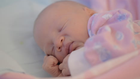 newborn baby girl moving being asleep