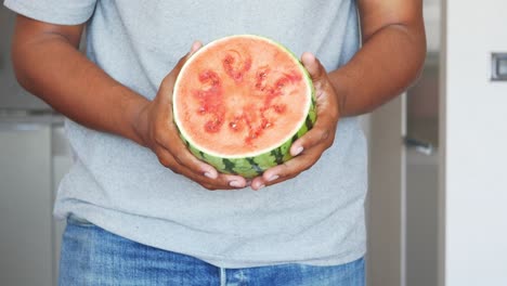 person holding a sliced watermelon