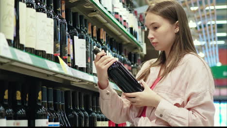 woman shopping for wine in a grocery store