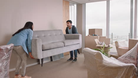 young-couple-moving-house-new-home-owners-smiling-enjoying-successful-move-hugging-in-apartment