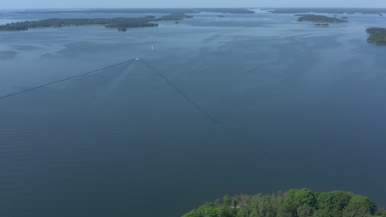Boats driving in the waters of the Stockholm archipelago, tilt up aerial