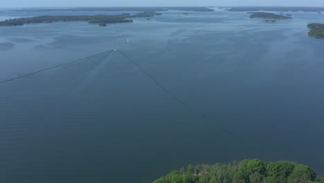 boats driving in the waters of the stockholm archipelago, tilt up aerial