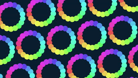 a vibrant array of rainbow colored circles forms a circular pattern against a black backdrop in this captivating and colorful image