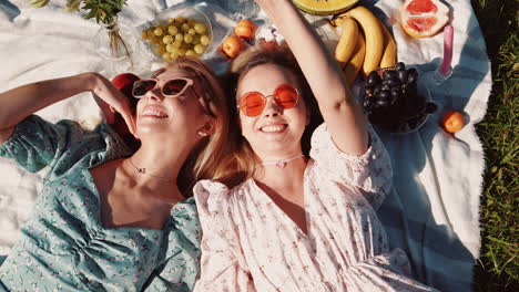 two friends enjoying a sunny picnic